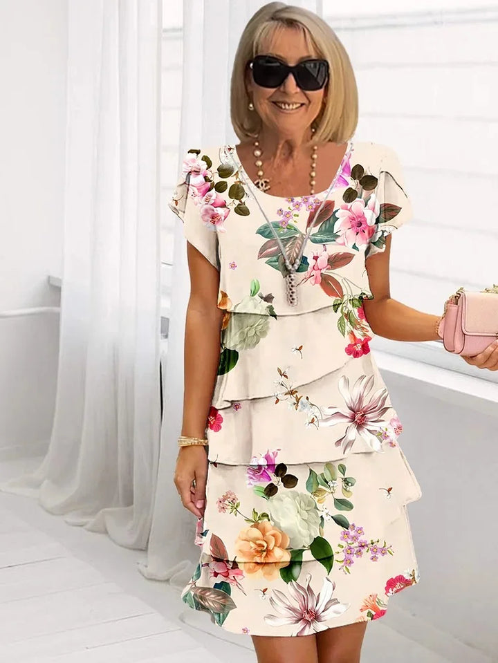 Vibrant floral pleated midi dress for women, featuring ruffles and adjustable straps. Perfect for summer days.
