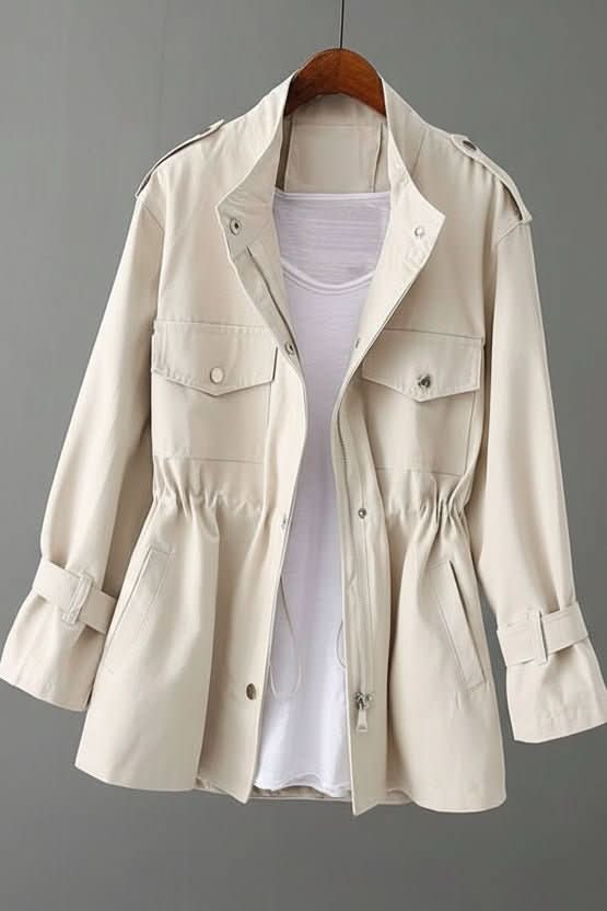 Unique women's utility jacket featuring a fashionable open back. This modern outerwear adds a chic touch to casual outfits.