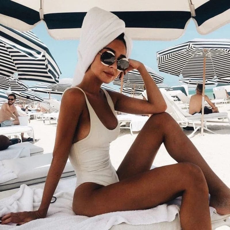 Flattering women's scoop neck one-piece with an elegant open back, ideal for poolside relaxation.