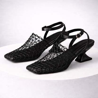 Fashionable women's heels featuring a sculpted heel, sleek pointed toe, and secure ankle strap design.