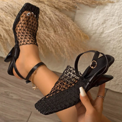 Chic women's pointed toe heels with a unique sculpted heel and delicate ankle strap, fashion-forward style.