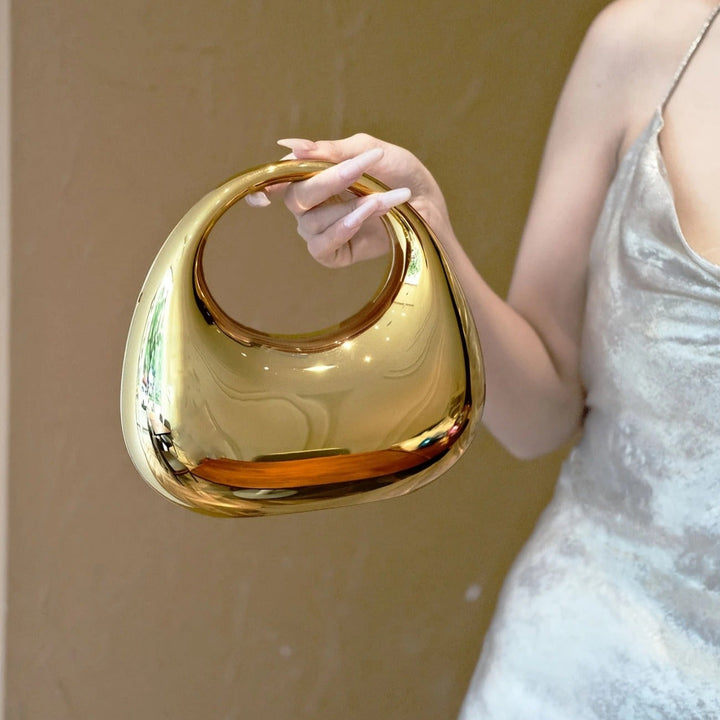Chic women's party purse with a unique mirror finish and modern sculptural design.