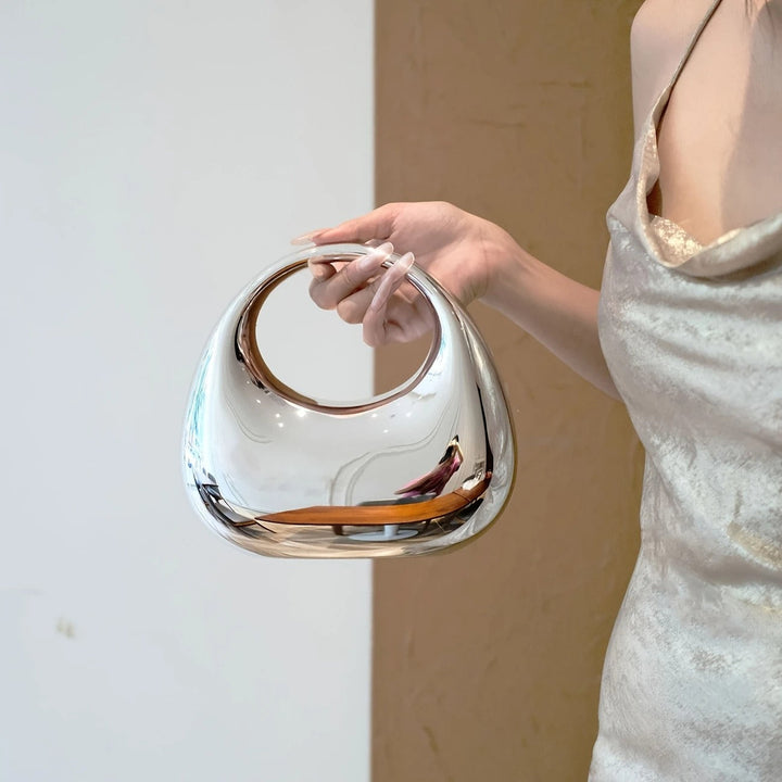 Fashionable women's party bag, sculptural design, eye-catching mirror finish.