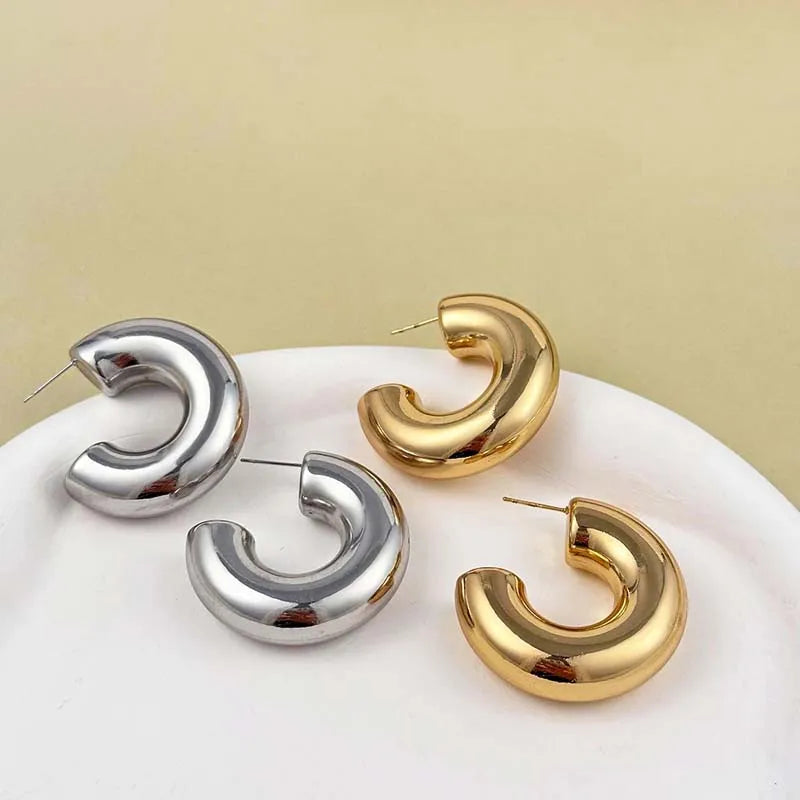 Modern sculptural hoop earrings, featuring a radiant gold and silver shine, perfect women's jewelry.