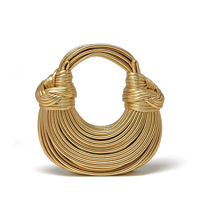 Smooth vegan leather sculptural handbag for women. Sustainable luxury fashion accessory.
