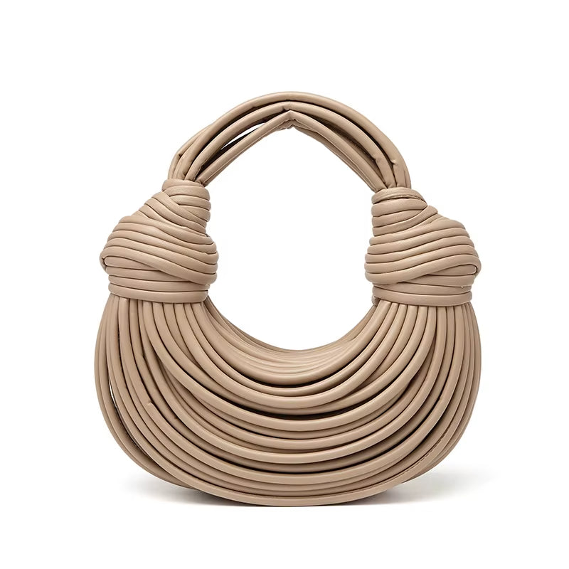 Stylish women's sculptural vegan leather shoulder bag. Fashionable & practical luxury accessory.