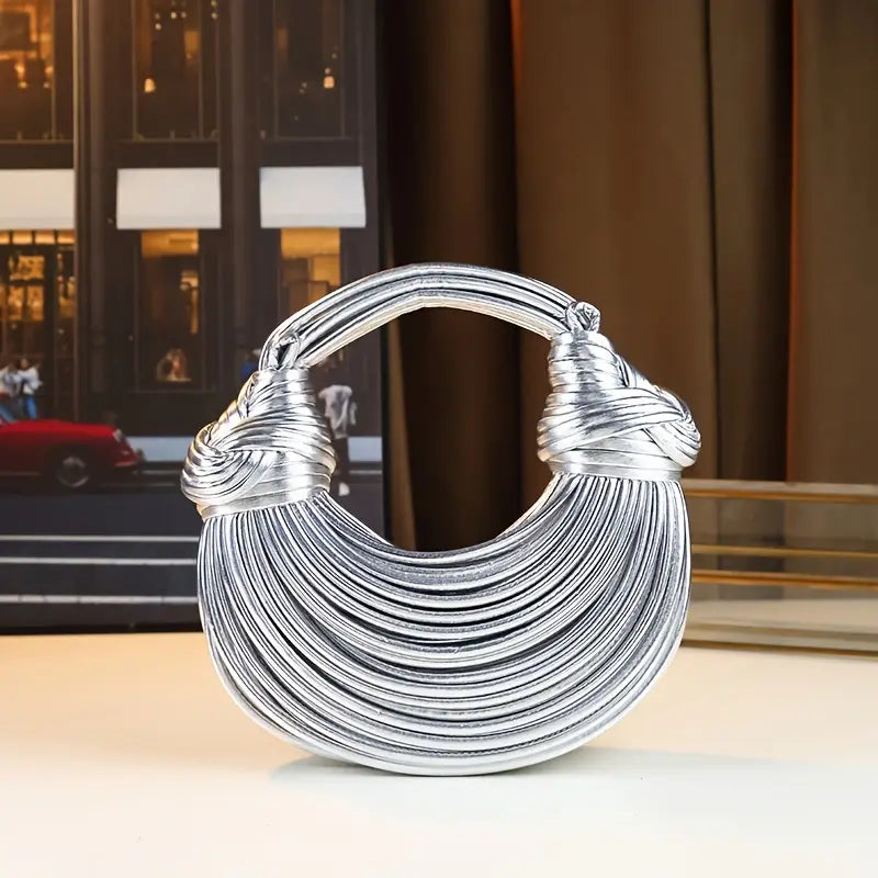 Luxury women's sculptural vegan leather handbag. Trendy fashion accessory, elegant & modern design.