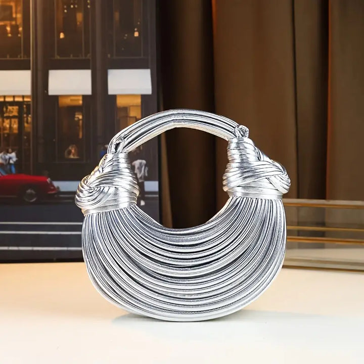 Luxury women's sculptural vegan leather handbag. Trendy fashion accessory, elegant & modern design.