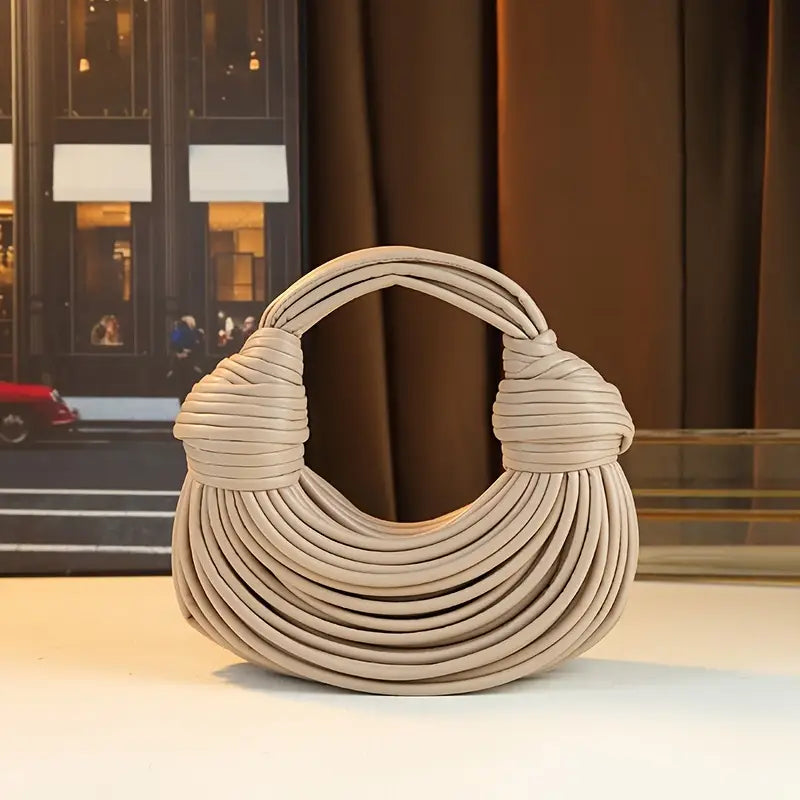 Women's sculptural vegan leather handbag. Stylish shoulder bag, a chic fashion accessory for women.