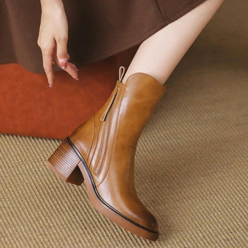 Side view of Selene women's heeled ankle boots, featuring a sleek silhouette and secure side zipper closure.