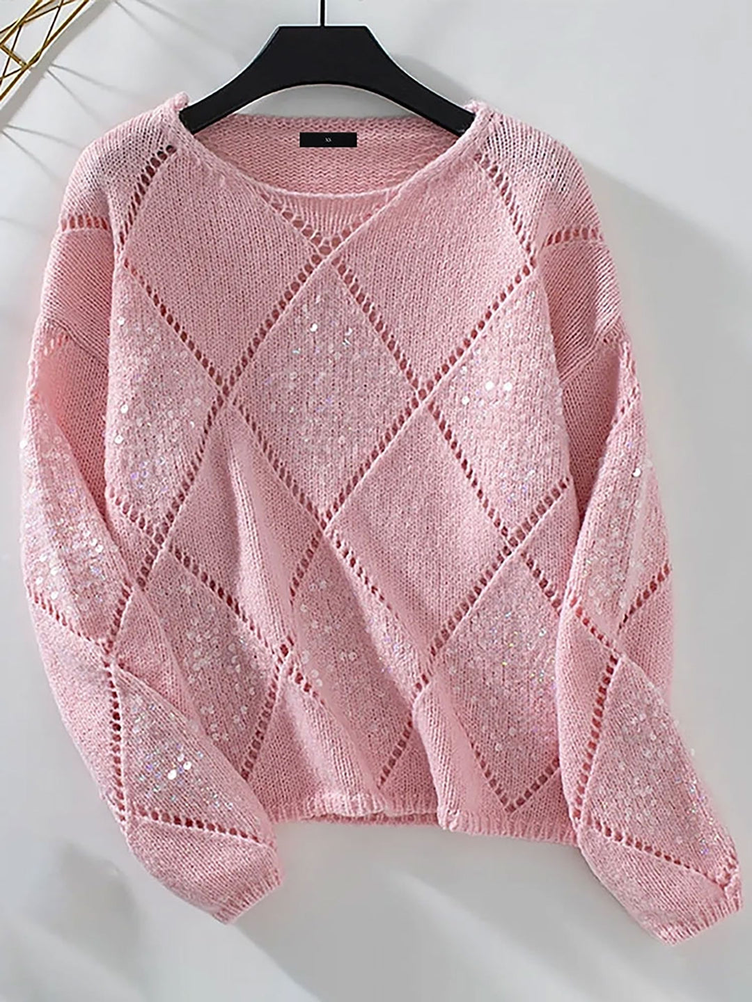 Women's sparkling sequin sweater with a detailed diamond pattern, perfect as a festive holiday outfit.