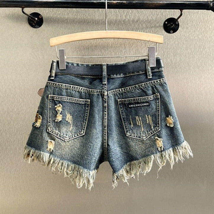 Stylish sequined floral shorts for women, featuring a button fly. Ideal for sparkling summer fashion.
