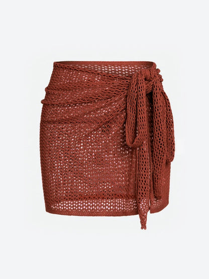 Stylish women's sheer knit cover-up skirt for beach & pool, perfect over swimwear, vacation-ready.
