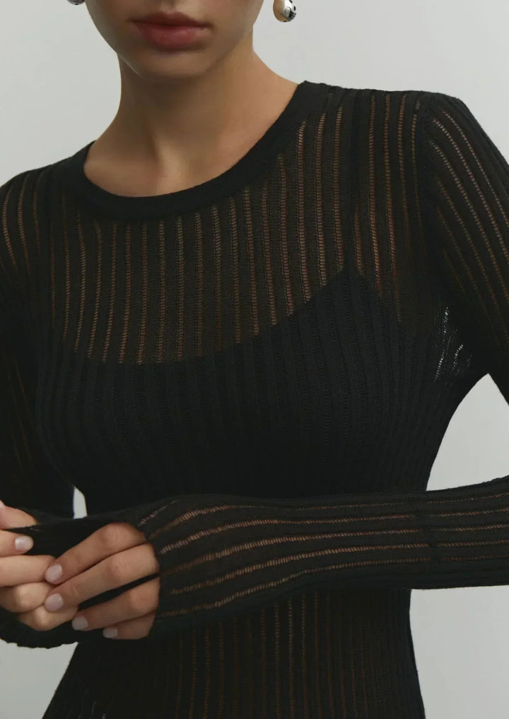 Close-up of sheer ribbed long sleeve top texture, a chic women's fitted blouse for day to night.