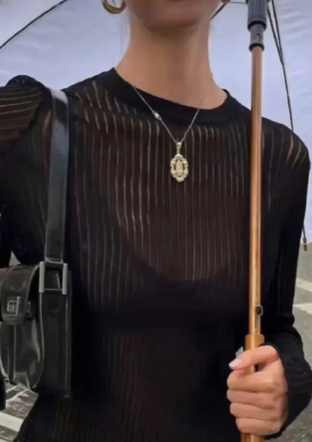 Elegant women's sheer ribbed long sleeve top, a fitted modern blouse ideal for sophisticated casual wear.