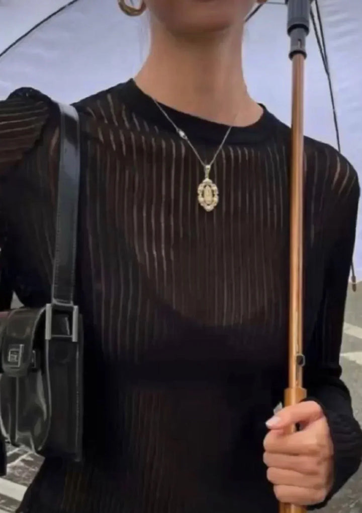 Elegant women's sheer ribbed long sleeve top, a fitted modern blouse ideal for sophisticated casual wear.