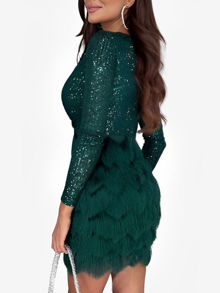Sparkling homecoming mini dress featuring a stylish wrap design and playful fringe.