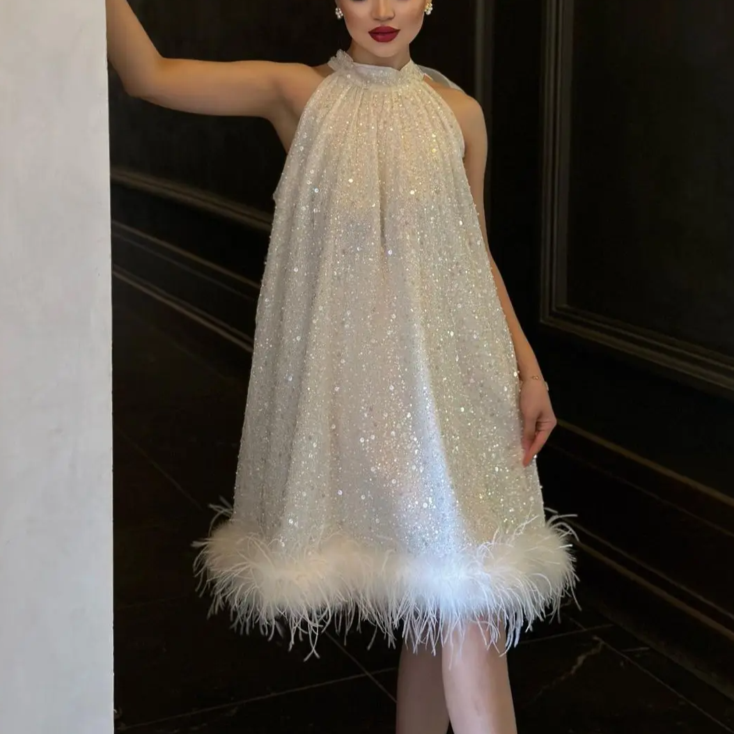 Women's shimmering sequin feather evening dress. Glamorous party fashion, perfect for special occasions & cocktail attire.