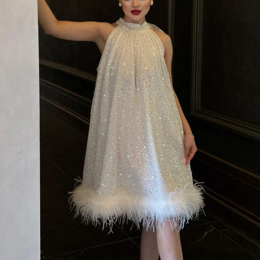 Women's shimmering sequin feather evening dress. Glamorous party fashion, perfect for special occasions & cocktail attire.