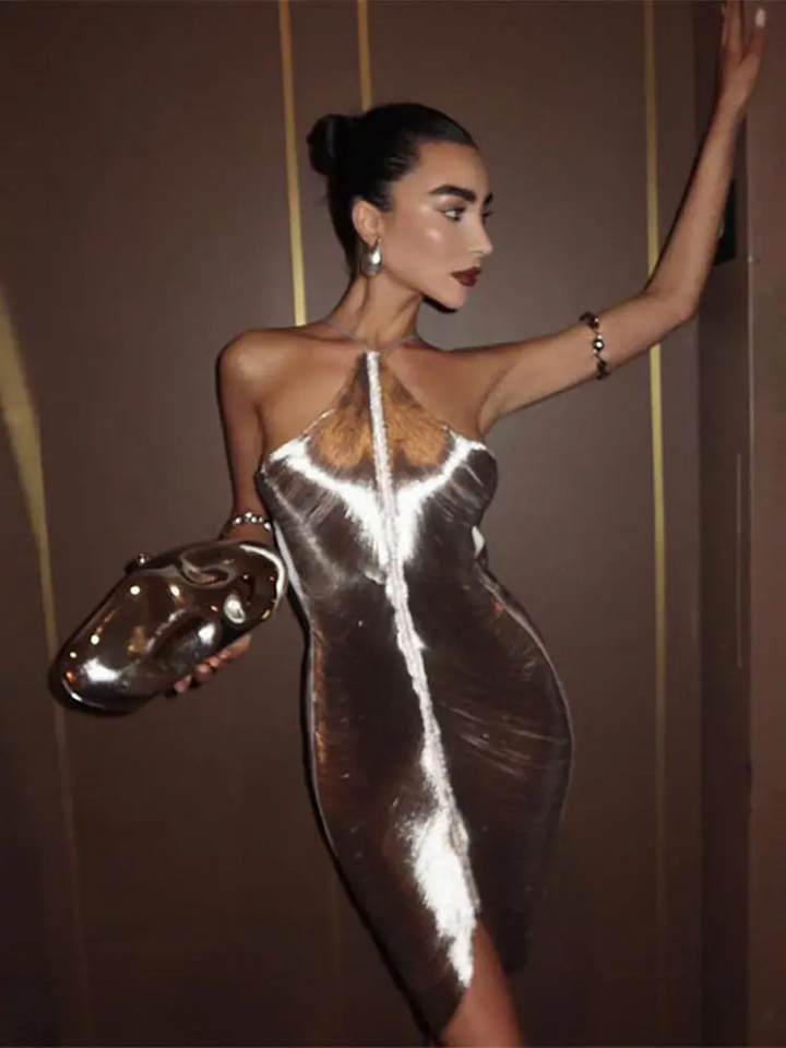 Elegant women's metallic mini dress in a shimmering silver fabric. Ideal for evening wear & glamorous fashion events.