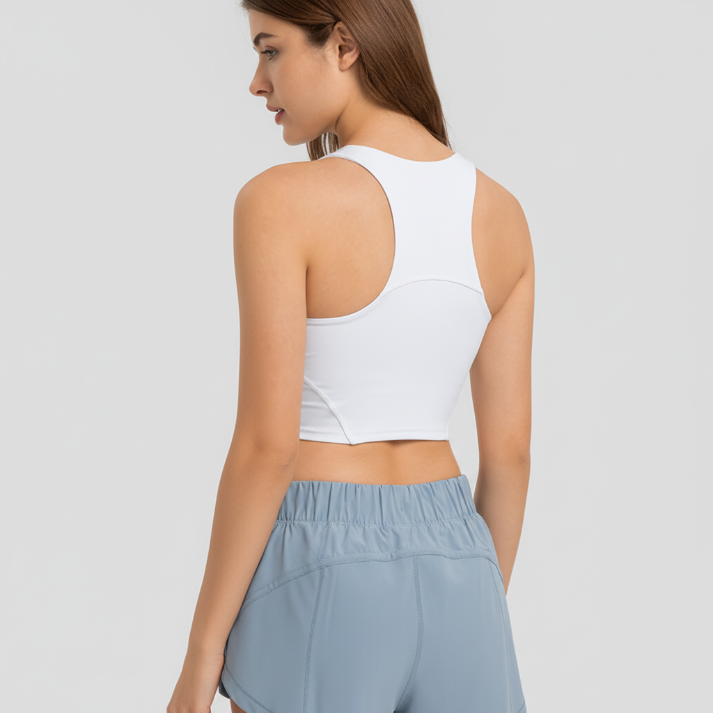 Athletic women's racerback crop top, supportive design, removable pads for optimal workout comfort.