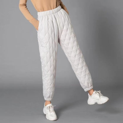 Close-up of women's Sierra quilted pants, showing soft fabric and intricate diamond stitch for chic comfort.