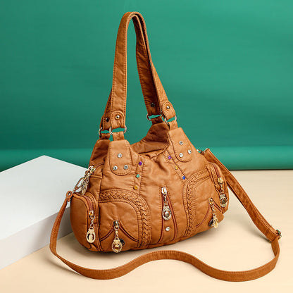 Stylish signature faux leather handbag for women. Perfect as a shoulder or crossbody bag.