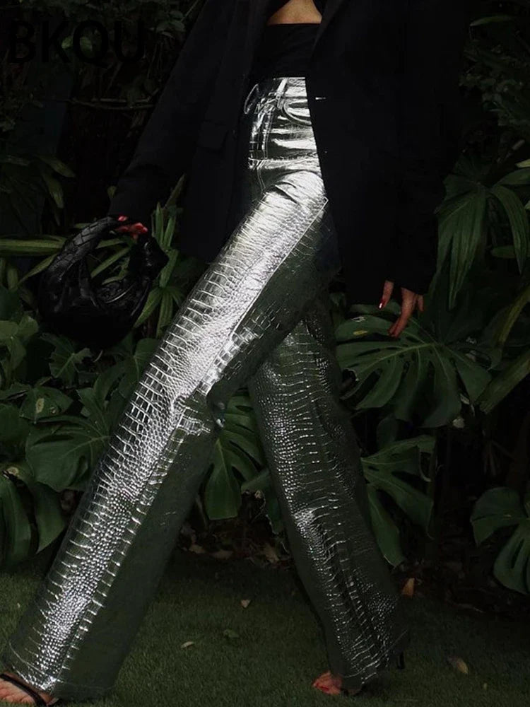 Shimmering silver women's sleek designer style pants. Modern trousers for elegant evening or party wear.