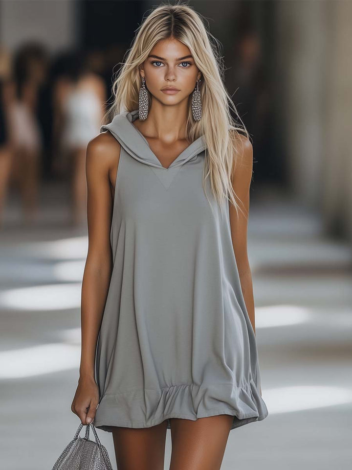 Women's sleeveless hooded mini dress with playful ruffle hem, perfect for casual summer style.