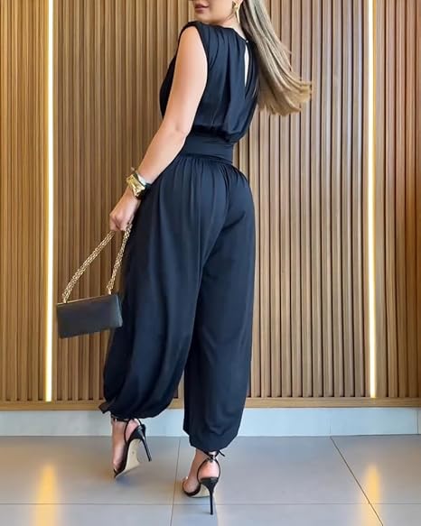 Woman in an elegant sleeveless high waist balloon leg jumpsuit. Perfect for special occasions.