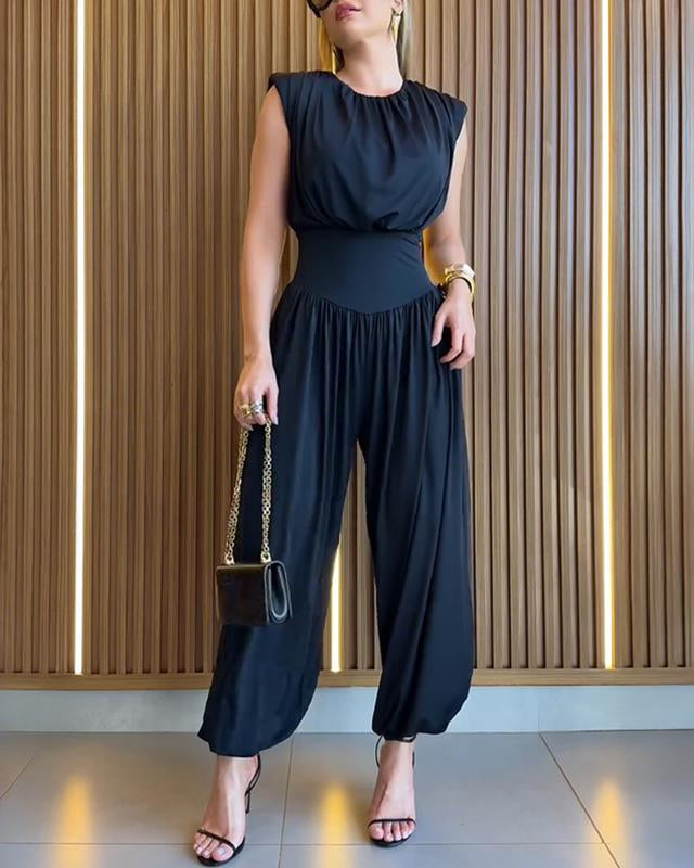 Sleeveless women's jumpsuit with cinched high waist, flowy balloon legs. A fashionable formal romper.