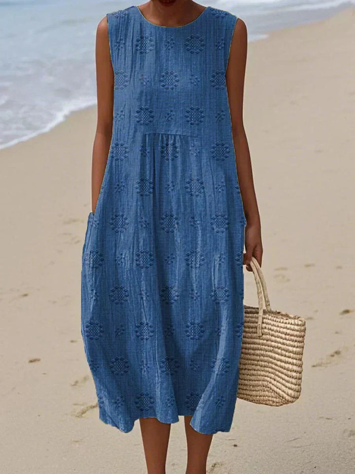 Flowy sleeveless midi dress for women, featuring convenient pockets. Perfect comfortable and versatile summer fashion.