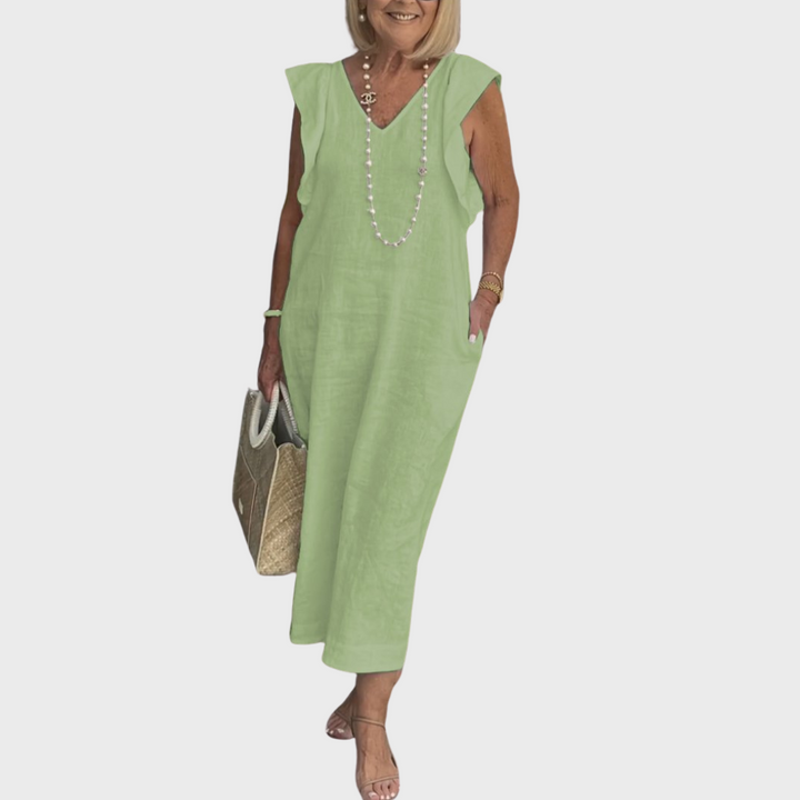 Chic women's resort wear maxi dress. Sleeveless, V-neck, elegant ruffle shoulders, and handy pockets.