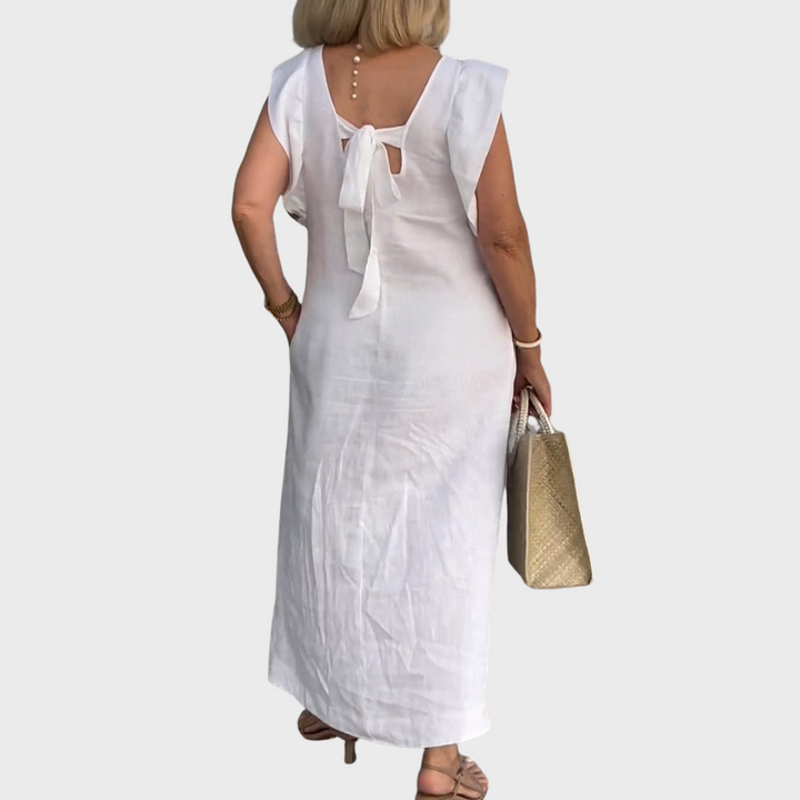 Casual women's summer maxi dress with a V-neck, ruffle shoulders, and convenient pockets. Sleeveless style.