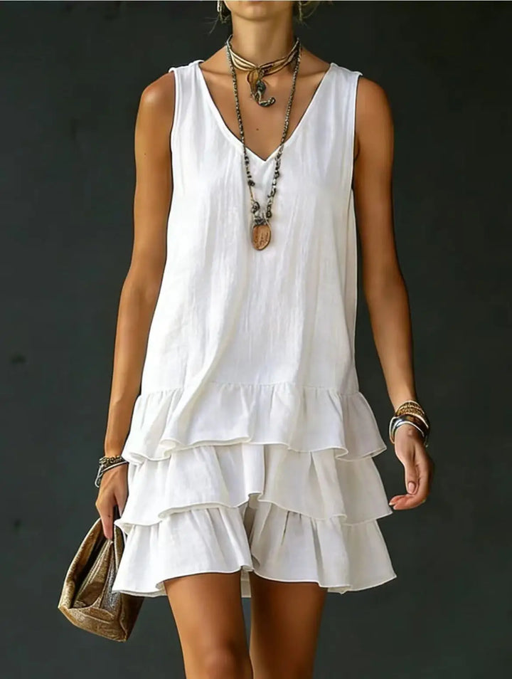 Flowy tiered mini dress for women featuring delicate ruffles & chic V-neck, ideal for vacation.