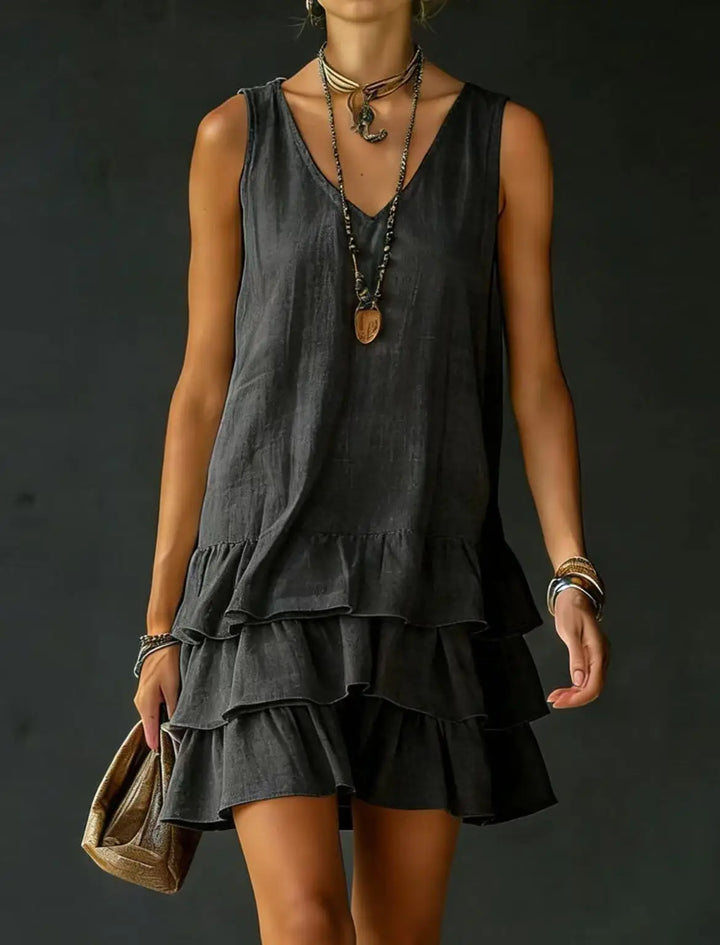 Elegant V-neck sleeveless mini dress with multiple ruffle tiers, perfect for a chic summer fashion look.