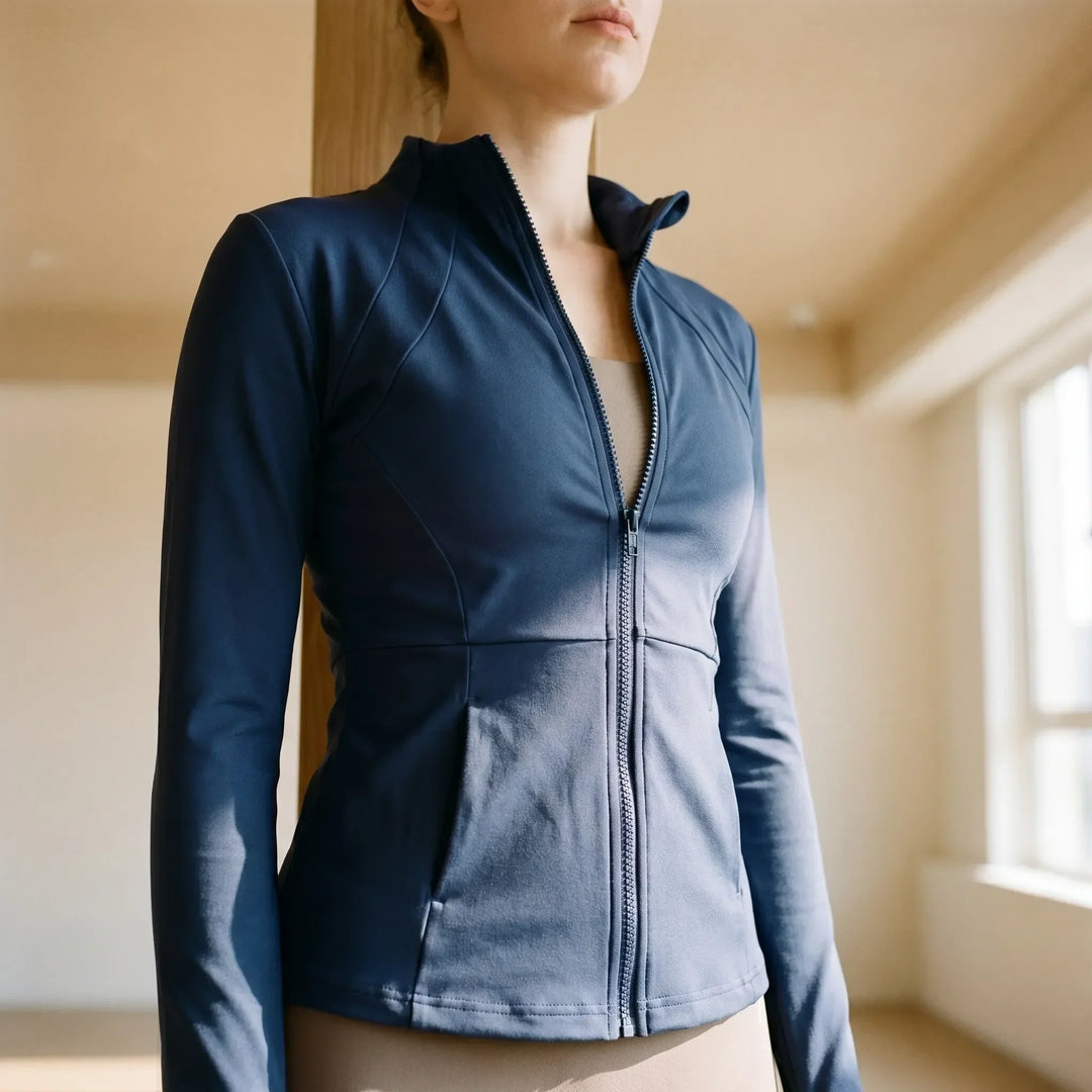 Women's slim-fit activewear jacket in black, ideal for running, gym, and yoga workouts. Performance athletic wear.