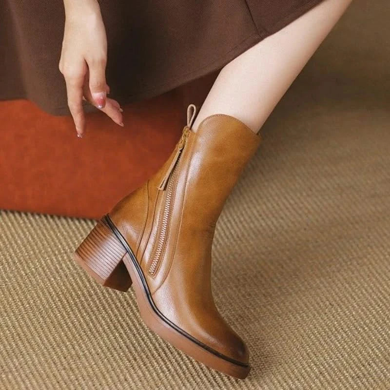Side view of black Sloane high-heel ankle boots, showcasing sleek design & comfortable fit.