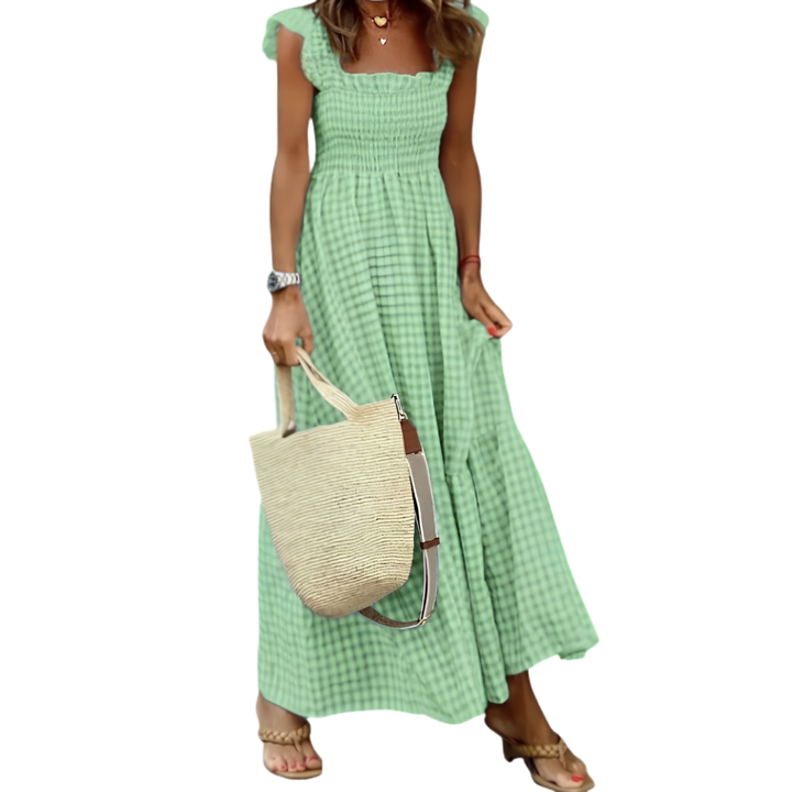 Women's smocked tiered maxi dress, a stylish summer essential. Features pockets and a comfortable, flowy design.