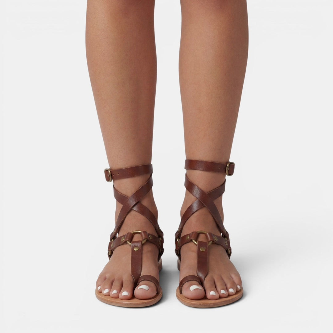 Stylish women's snake print flat sandals, featuring crossover design & buckle closure for comfortable everyday wear.