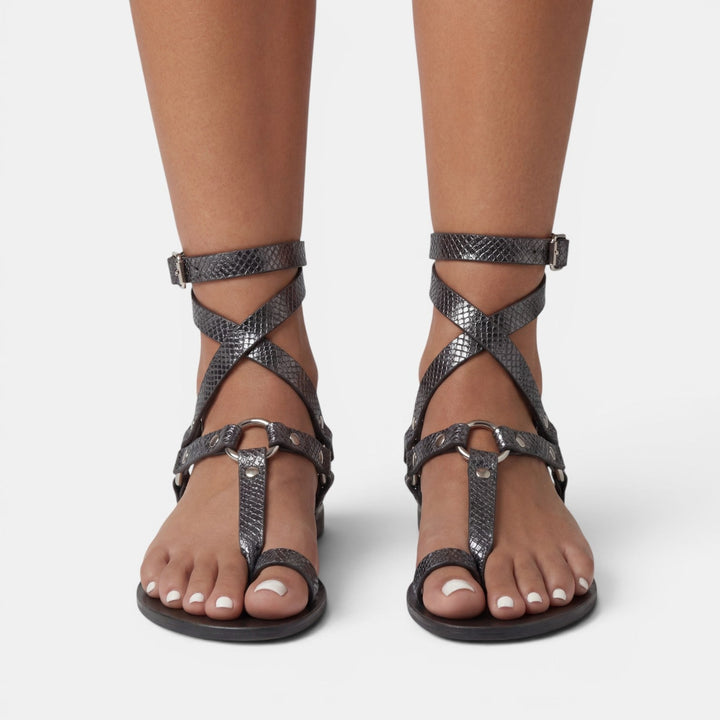 Elegant women's flat sandals: snake print crossover straps with buckle, offering both comfort and fashion.