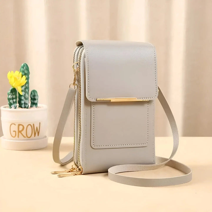 Side view of a sleek women's soft black leather anti-theft shoulder bag, compact & functional.