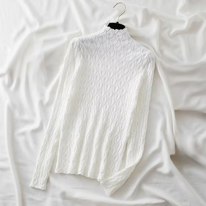 Woman models a stylish cashmere blend turtleneck sweater, ideal for elegant winter outfits.