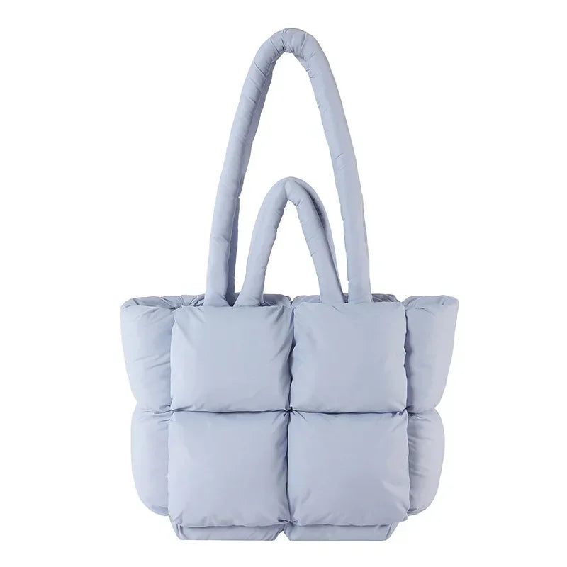 Fashionable women's puffer tote bag, chic padded design. Versatile shoulder handbag for a stylish look.