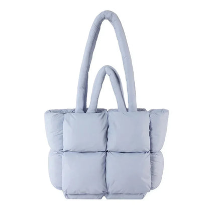 Fashionable women's puffer tote bag, chic padded design. Versatile shoulder handbag for a stylish look.