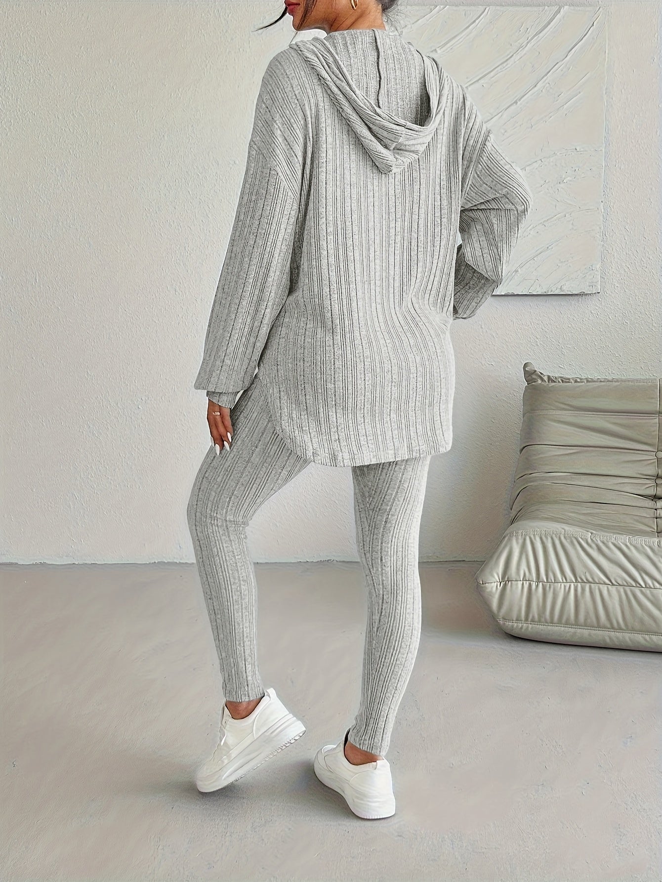 Detail shot of the drawstring on a women's ribbed knit hoodie, part of a comfortable lounge set.