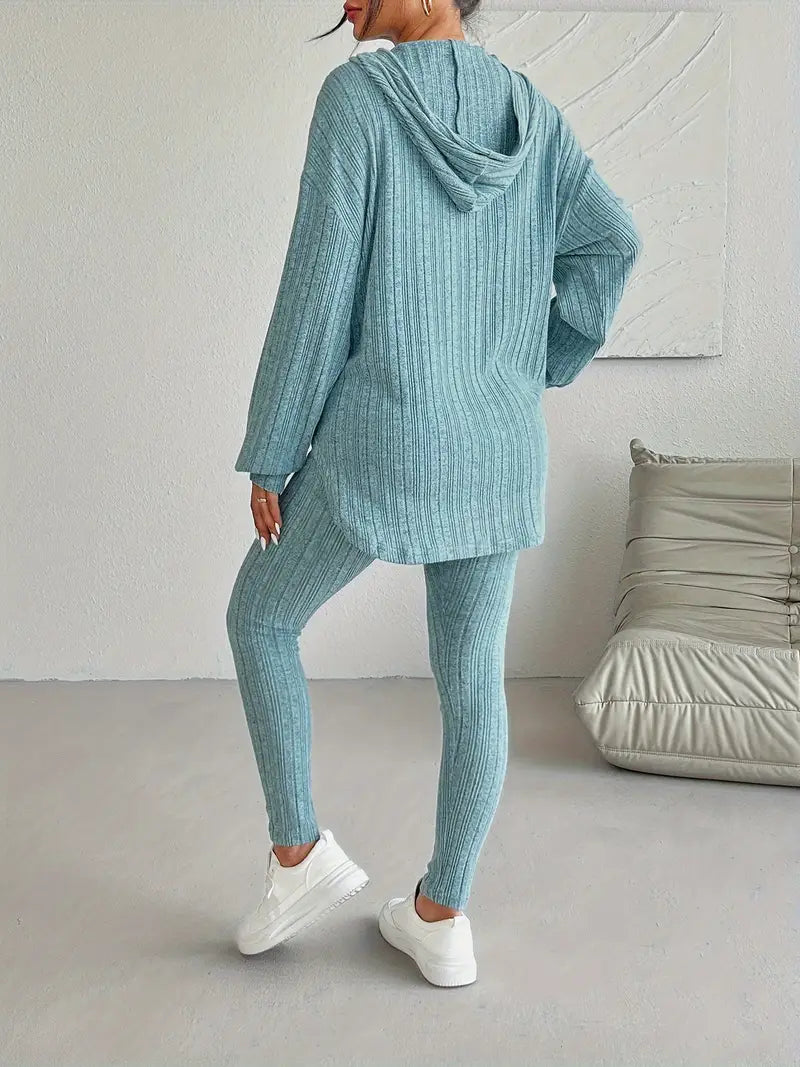 Full length view of a woman wearing a soft ribbed knit lounge set with hoodie and leggings, for home or casual wear.