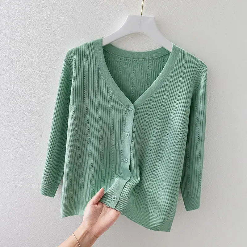 Close-up of a women's soft ribbed knit cardigan, highlighting the V-neckline & textured fabric detail.