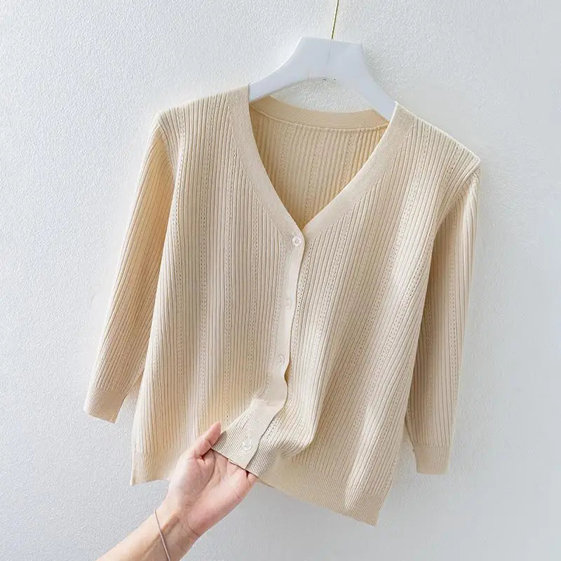 Woman wearing a comfortable, long sleeve ribbed knit v-neck cardigan, styled as a versatile casual top.