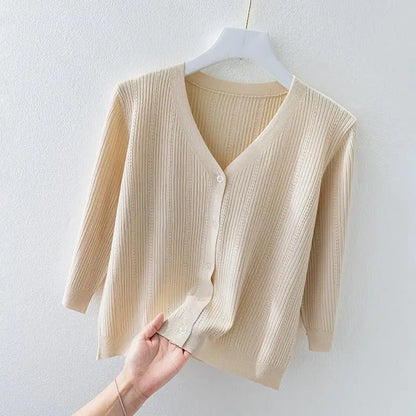 Woman wearing a comfortable, long sleeve ribbed knit v-neck cardigan, styled as a versatile casual top.